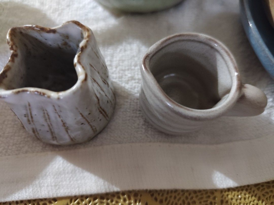 Handmade Ceramic Creamer Pitcher and Small Cup (Category: Coffee & Tea Tableware) located in Manila. Submitted by marriage031073advocate (Listing ID 1464420564, Image 2). Description: - Set includes one ceramic creamer pitcher with handle and one unique jug. - Rustic, handmade aesthetic. - Features a light glaze with charming brown speckles. - Ideal for serving cream, sauces, or as unique kitchen decor..