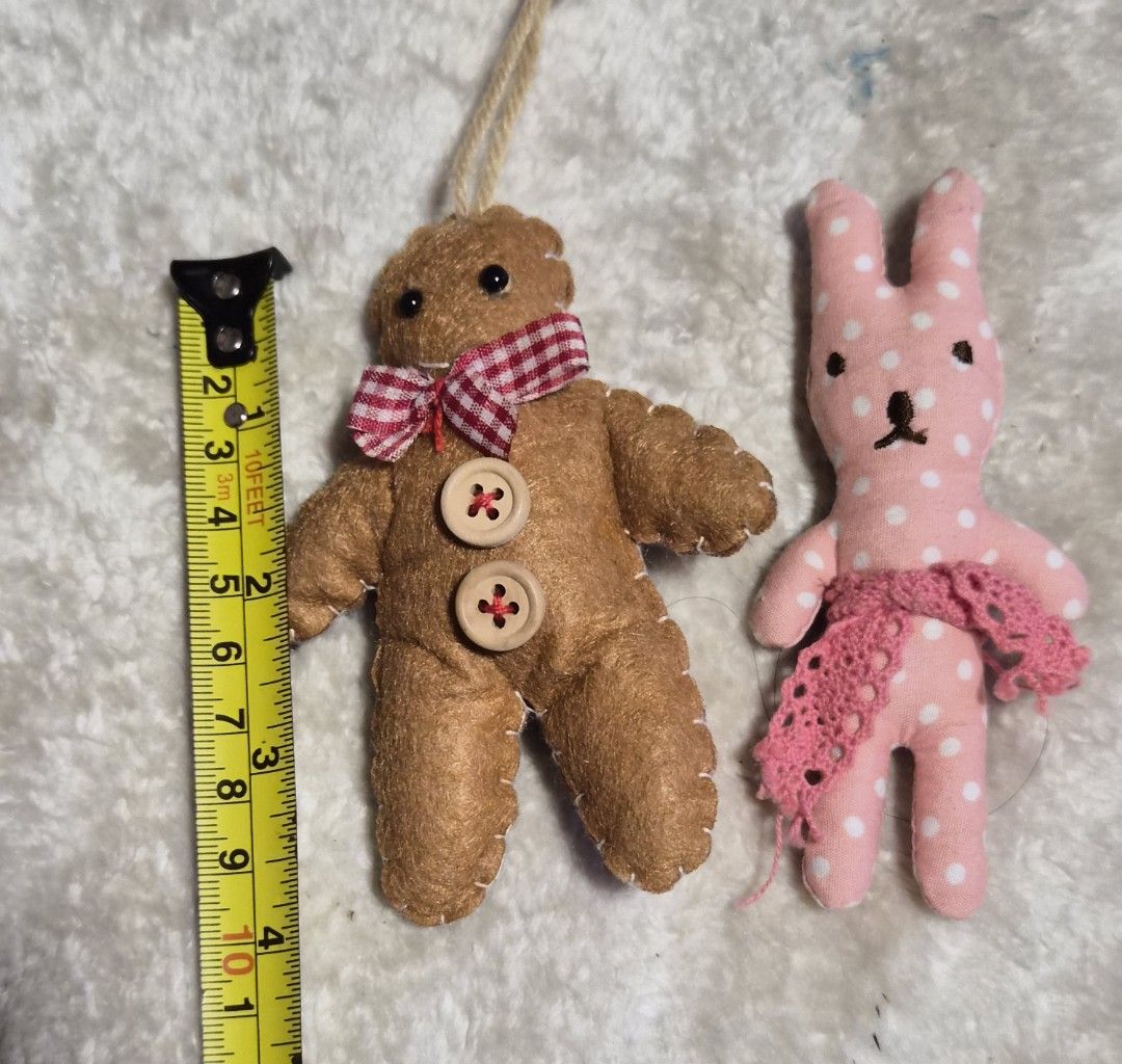 Handmade Gingerbread Man & Bunny Plush Ornaments (Category: Plushies & Soft Toys) located in Mandaue City. Submitted by chuchi152615 (Listing ID 1464404112, Image 3). Description: - Adorable handmade plush ornaments - Gingerbread man: features buttons and a red gingham bow, includes a hanging loop - Pink bunny: adorned with white polka dots and a pink lace skirt, has a clip on the back - Perfect for festive decorations or as a charming small gift