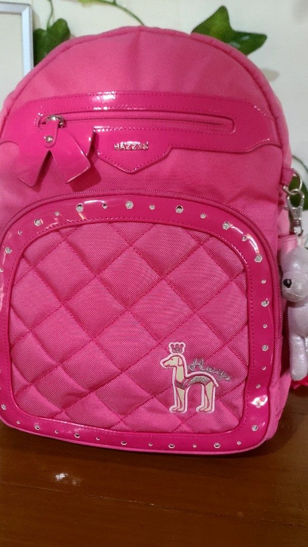Hazzys Pink Quilted Backpack with Charm (Category: Backpacks) located in Baguio. Submitted by phoeberose33384 (Listing ID 1464567631, Image 2). Description: - Cute pink Hazzys backpack - Quilted front with sparkly trim - Comes with a little dog charm - Main compartment and front zip pocket - Adjustable straps - Measures about 14 x 10 inches.