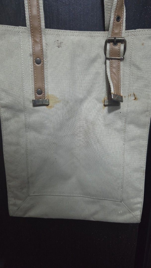 Hello Kitty Canvas Tote Bag (Category: Tote Bags) located in Quezon City. Submitted by kctheexplorer05 (Listing ID 1464546786, Image 2). Description: - Adorable Kitty canvas tote bag - Natural beige color - Adjustable straps with stylish buckle details - Convenient interior pocket - Ideal for everyday errands and activities -it's brand new still got tag however due to poor storage got visible stains behind (check photos for reference).
