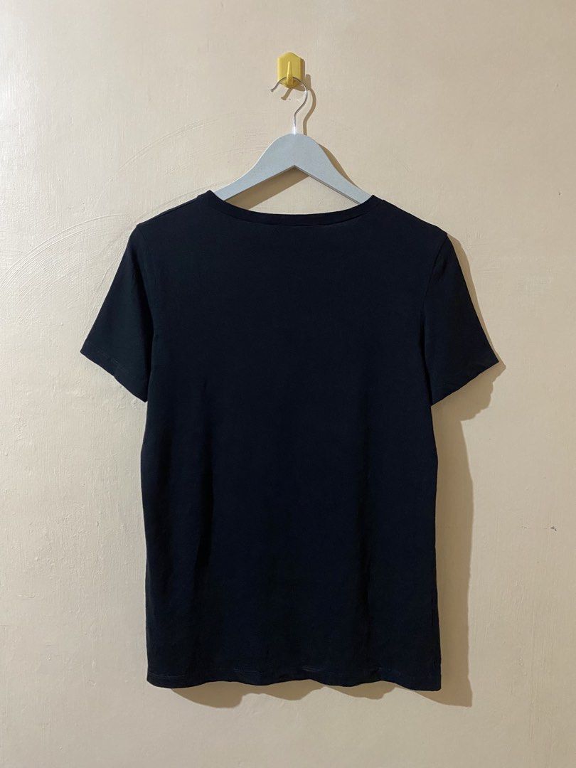 Helmut Lang Limited Edition Logo T-Shirt (Category: Luxury Apparel) located in Naga. Submitted by dailyshipped (Listing ID 1464476014, Image 3). Description: This item is Helmut Lang Limited Edition Logo T-Shirt in black featuring a contrasting vibrant blue graphic across the chest. The text layout mimics classic promotional brand merchandise, cleanly balancing bold corporate branding with minimalistic, lower-case address fine print detailing the