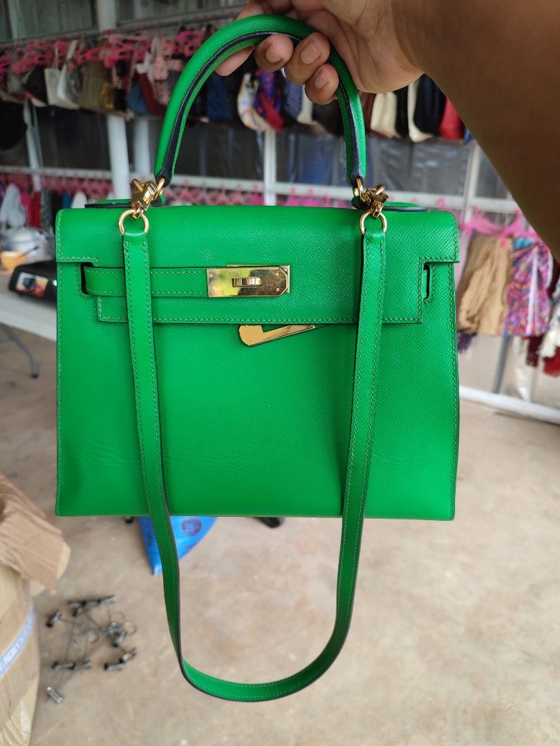 Hermes Kelly Green Leather Handbag (Category: Luxury Bags & Wallets) located in Puerto Princesa. Submitted by thriftedsoulsy2k (Listing ID 1464417893, Image 1). Description: - Vibrant bright green leather handbag - Elegant gold hardware details - Versatile top handle and detachable shoulder strap - Classic structured design, ideal for everyday or special events - Convenient size: approximately 25cm wide.