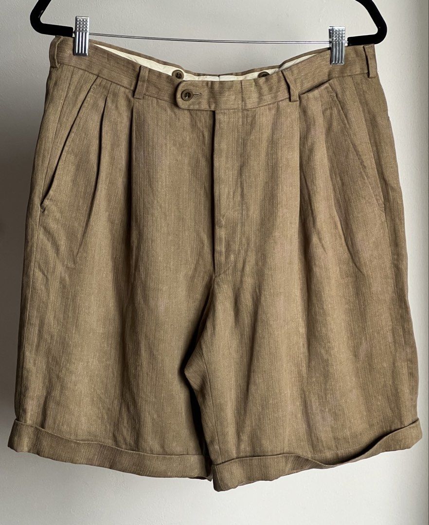 Hermes Pleated Linen Blend Shorts Tan (Category: Luxury Apparel) located in Quezon City. Submitted by raccoonfur (Listing ID 1464414768, Image 1). Description: Hermes tailored short pants in 100% linen. Has some stains and fadings all around. Not that conspicuous when worn, somehow blends through. Back seam stitch lines. Great condition nonetheless. Has that old money nonchalance. Flat measurements: Waist 42cm/16.5in Length 53.25cm/21in Crotch 36