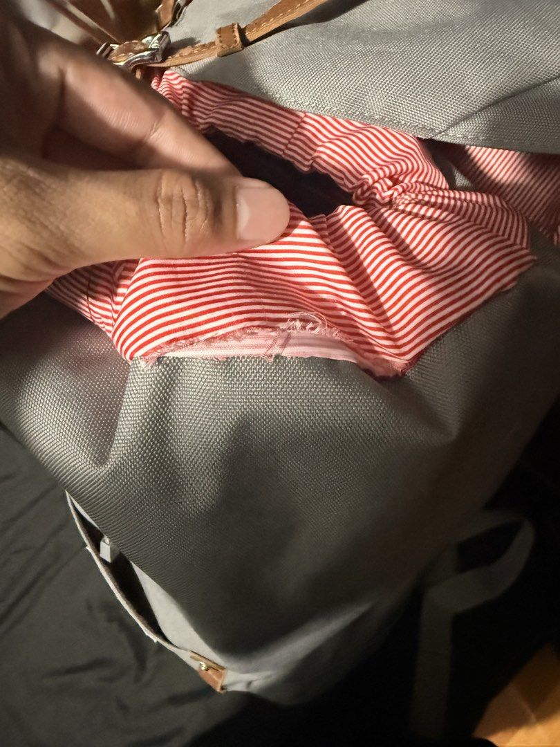 Herschel Grey Backpack with Brown Leather Straps (Category: Backpacks) located in Manila. Submitted by meguminnn24 (Listing ID 1464504881, Image 2). Description: - Classic Herschel backpack in grey - Features brown leather straps and buckle closures - Signature red and white striped interior lining - Small tear on inside pocket lining (photos available) - Plenty of life left, perfect for everyday use or travel - issue nasa last pic.