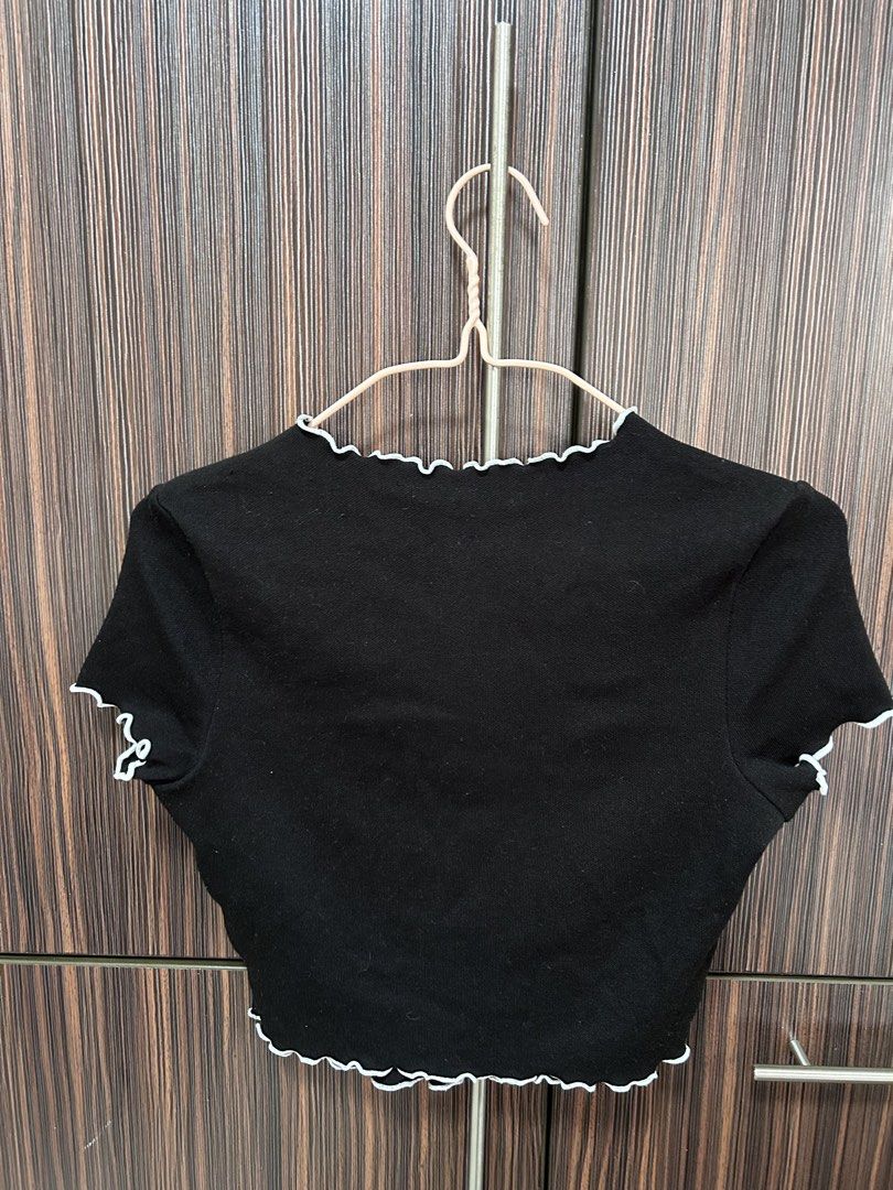 H&M Black Frilly Crop Top Size XS (Category: Sleeveless) located in Cebu City. Submitted by pau.ky (Listing ID 1464487336, Image 3). Description: -RFS: Decluttering -Cute black crop top from H&M - Size XS - Features frilly details on neckline and sleeves - Short sleeves - Button-up front - No stains or tears - Item may appear different due to lighting.