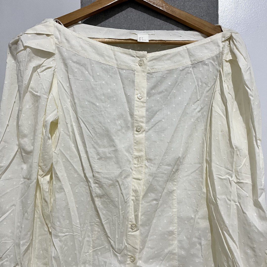 H&M White Puff Sleeve Button-Up Blouse (Category: Blouses) located in Manila. Submitted by samanthamaeb (Listing ID 1464493171, Image 2). Description: Light yellow. Off shoulder blouse. Not really used. With some brown stains due to storage but I think it can be removed. .