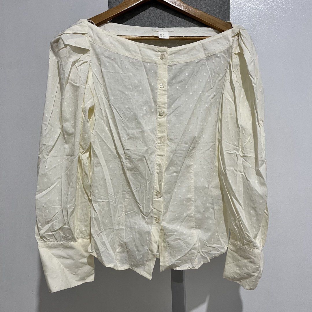 H&M White Puff Sleeve Button-Up Blouse (Category: Blouses) located in Manila. Submitted by samanthamaeb (Listing ID 1464493171, Image 1). Description: Light yellow. Off shoulder blouse. Not really used. With some brown stains due to storage but I think it can be removed. .