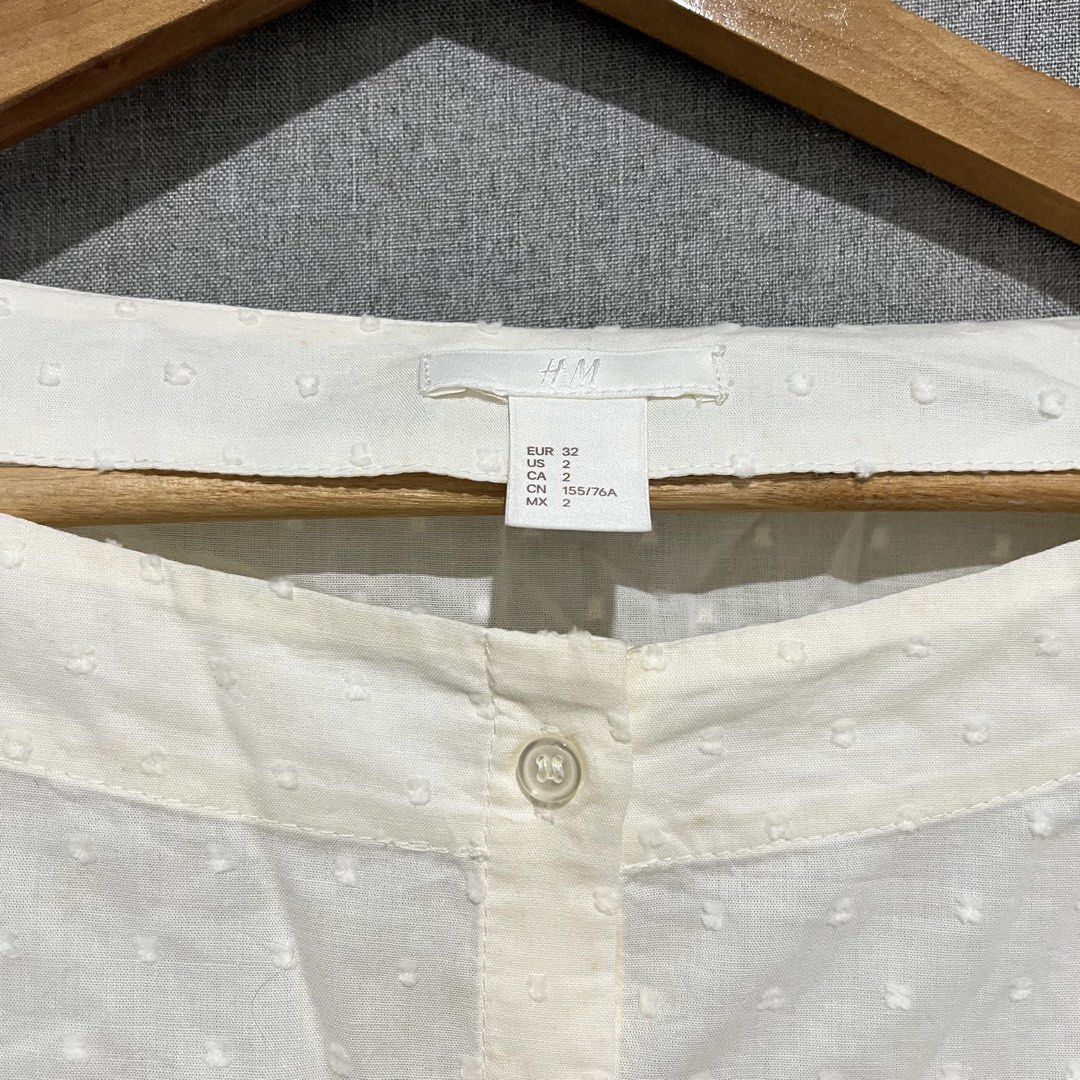 H&M White Puff Sleeve Button-Up Blouse (Category: Blouses) located in Manila. Submitted by samanthamaeb (Listing ID 1464493171, Image 3). Description: Light yellow. Off shoulder blouse. Not really used. With some brown stains due to storage but I think it can be removed. .