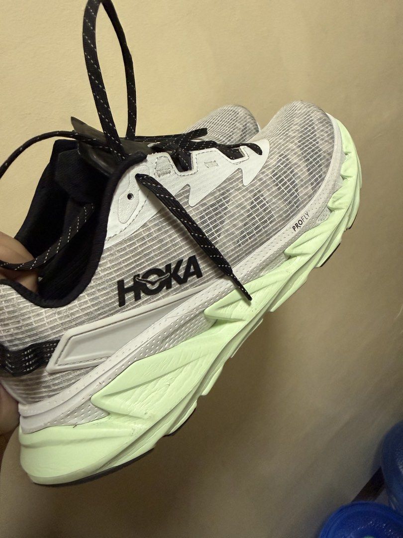 Hoka One One U Elevon 2 (Category: Sneakers) located in Rizal. Submitted by rarestorm.99d68b (Listing ID 1464497133, Image 1). Description: - Hoka One One U Elevon 2 TS Running Shoes - Size: US Women's 11 - Color: Light Grey & White upper with Neon Green sole - Features: ProFly cushioning - Ideal for: Running and everyday wear - Includes: Original box.