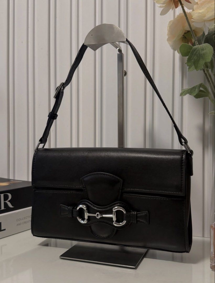 Horsebit Black medium pochette (Category: Shoulder Bags) located in Las Pinas. Submitted by vinccid (Listing ID 1464392518, Image 2). Description: ▪️NGA/ korea thrifted ▪️with minor rubber lining issue in strap ▪️with code.