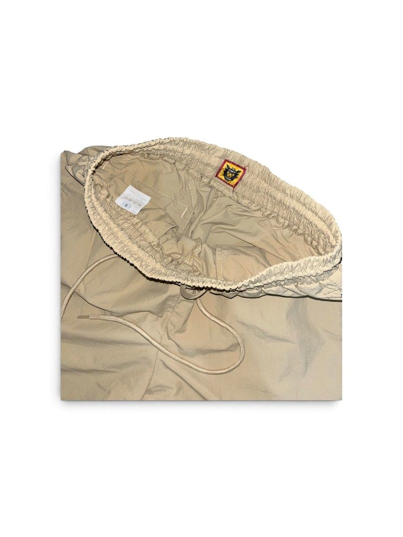 Human Made Shorts (Category: Shorts) located in Nabua. Submitted by lastthrift2.0 (Listing ID 1464516102, Image 3). Description: Dimes•26-30x17 •Above the knee •Nylon short - Beige cargo shorts from Human Made - Comfortable elastic waistband with drawstring - Subtle embroidered logo on the front left leg - Back pocket with distinctive stitching detail - Ideal for everyday casual wear.
