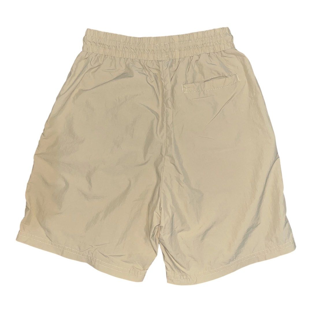 Human Made Shorts (Category: Shorts) located in Nabua. Submitted by lastthrift2.0 (Listing ID 1464516102, Image 2). Description: Dimes•26-30x17 •Above the knee •Nylon short - Beige cargo shorts from Human Made - Comfortable elastic waistband with drawstring - Subtle embroidered logo on the front left leg - Back pocket with distinctive stitching detail - Ideal for everyday casual wear.