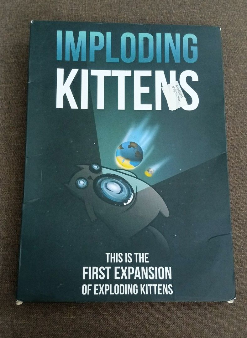 Imploding Kittens: First Expansion for Exploding Kittens Card Game (Category: Board Games & Puzzles) located in Seri Kembangan. Submitted by evie_prelovedclearance (Listing ID 1464499470, Image 1). Description: - First expansion deck for Exploding Kittens. - Adds 20 new cards illustrated by The Oatmeal. - Expands the core deck to support 5 to 6 players. - Includes a human-sized Cone of Shame turn indicator. - Requires a copy of the original Explo