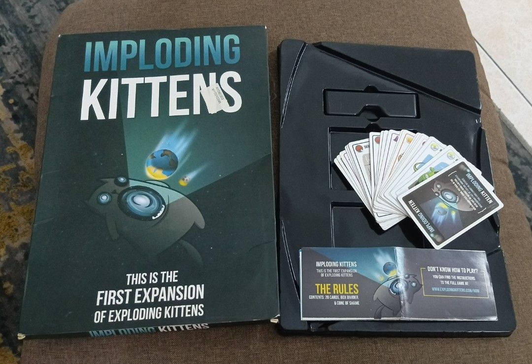 Imploding Kittens: First Expansion for Exploding Kittens Card Game (Category: Board Games & Puzzles) located in Seri Kembangan. Submitted by evie_prelovedclearance (Listing ID 1464499470, Image 3). Description: - First expansion deck for Exploding Kittens. - Adds 20 new cards illustrated by The Oatmeal. - Expands the core deck to support 5 to 6 players. - Includes a human-sized Cone of Shame turn indicator. - Requires a copy of the original Explo