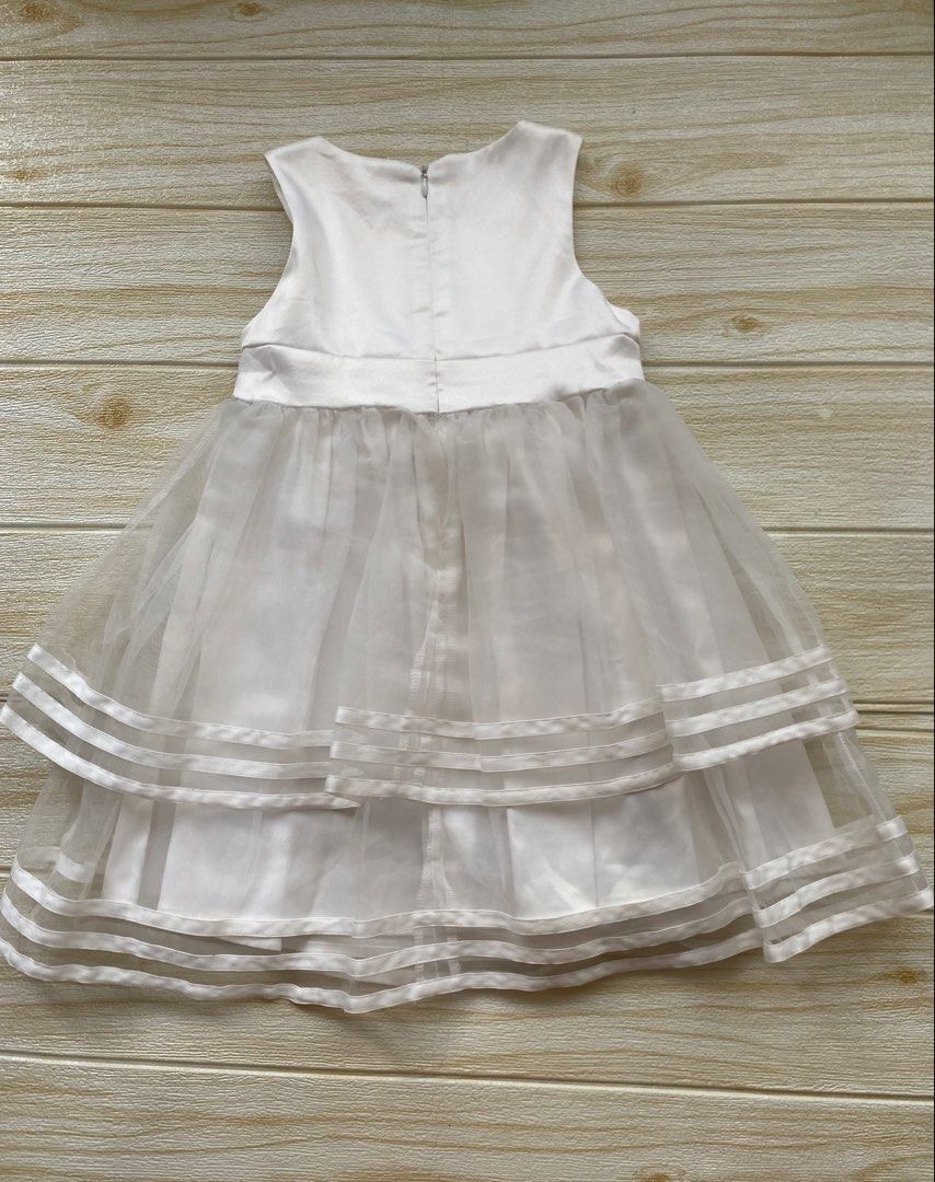 ivory party dress (Category: Babies & Kids Fashion) located in Cebu City. Submitted by yjainani (Listing ID 1464376606, Image 3). Description: featuring a prominent layered bow at the waist size 120.