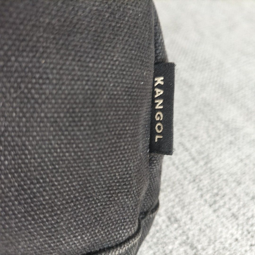 Kangol Black Canvas Drawstring Bucket Bag (Category: Cross-body Bags) located in Taytay. Submitted by calmtree-6248 (Listing ID 1464534783, Image 3). Description: - Brand: Kangol - Type: Bucket Bag - Color: Black Canvas - Features: Iconic kangaroo logo on front, drawstring closure, adjustable straps, structured base - Best for: Everyday use - Condition: Shows some signs of wear on straps and drawstring.