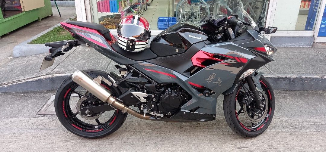 Kawasaki Ninja 400 Motorcycle (Category: Motorbikes for Sale) located in Manila. Submitted by ramilpadi51102 (Listing ID 1464478254, Image 2). Description: Kawasaki Ninja 400 Engine: 400cc Model: 2022 Acquired 2023 Color: Grey (w/ black & red cobination) Odo: 16k +++ Akrapovic Exhaust Pipe (original) Winglet Side Mirror Led Head Lights (H&L) Installed Auxillary LED Lights (H&L) With Stock Tools Thick Tires (rear & front) Installed Tank Knee Pads 