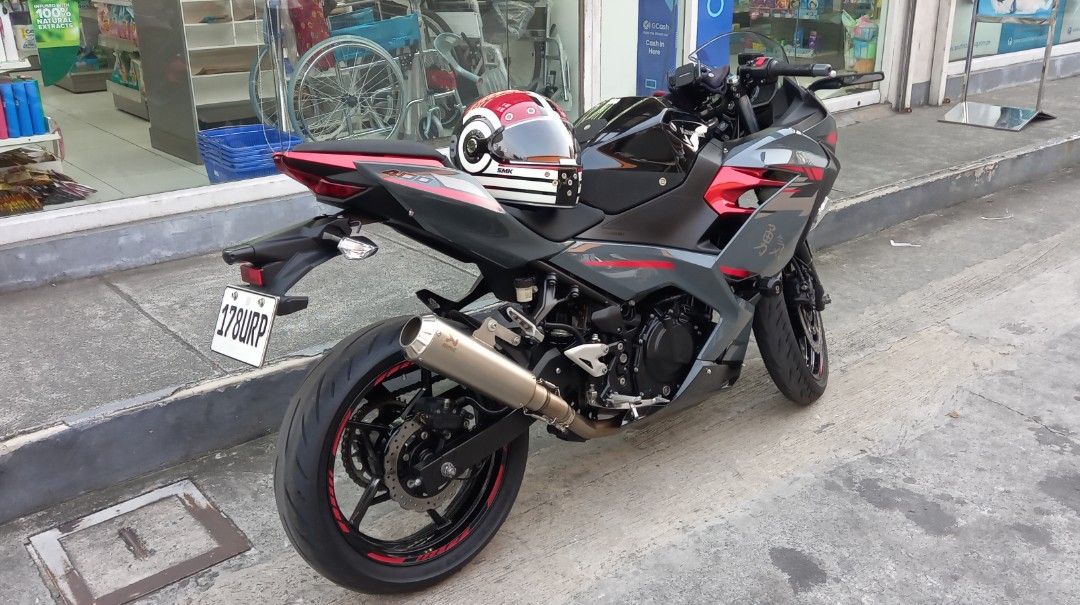 Kawasaki Ninja 400 Motorcycle (Category: Motorbikes for Sale) located in Manila. Submitted by ramilpadi51102 (Listing ID 1464478254, Image 3). Description: Kawasaki Ninja 400 Engine: 400cc Model: 2022 Acquired 2023 Color: Grey (w/ black & red cobination) Odo: 16k +++ Akrapovic Exhaust Pipe (original) Winglet Side Mirror Led Head Lights (H&L) Installed Auxillary LED Lights (H&L) With Stock Tools Thick Tires (rear & front) Installed Tank Knee Pads 