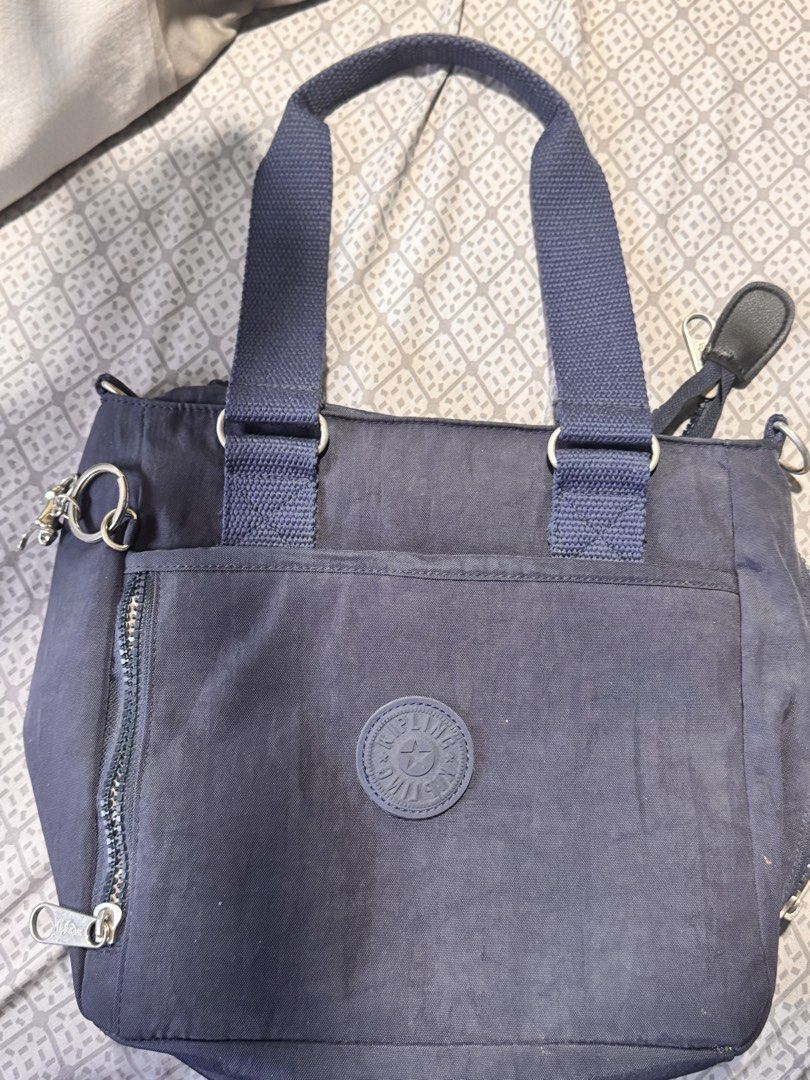 Kipling Navy Blue Nylon Shoulder Bag with Monkey Charm (Category: Shoulder Bags) located in Obando. Submitted by Wintermelonzzzz (Listing ID 1464379018, Image 1). Description: - Navy blue Kipling bag - Made from durable nylon - Features a front zip pocket - Adjustable shoulder straps for comfort - Includes the signature Kipling monkey charm - Fun patterned interior lining - Ideal for everyday use.