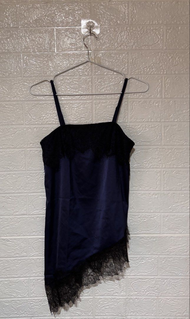 Lace Camisole Goth Coquette Y2K (Category: Sleeveless) located in Cebu City. Submitted by airahxoxo (Listing ID 1464510685, Image 1). Description: - Navy blue satin camisole - Black lace trim detail - Asymmetrical hemline - Adjustable spaghetti straps - Versatile for layering or standalone wear - Chic and stylish design.