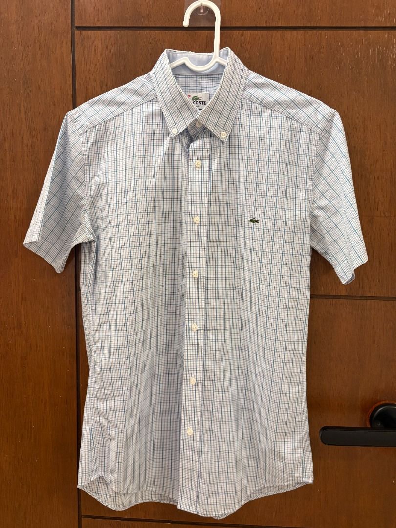 Lacoste Blue Check Short Sleeve Button-Down Shirt (Category: Tshirts & Polo Shirts ) located in Mandaluyong City. Submitted by jbor88 (Listing ID 1464367192, Image 1). Description: Brand: Lacoste Color: Light Blue & White Checkered Style: Short Sleeve Shirt Fit: Slim Fit Collar: Button Down Features: Iconic Lacoste Crocodile Logo on Chest Slim Fit 38 W=46cm L=71cm.