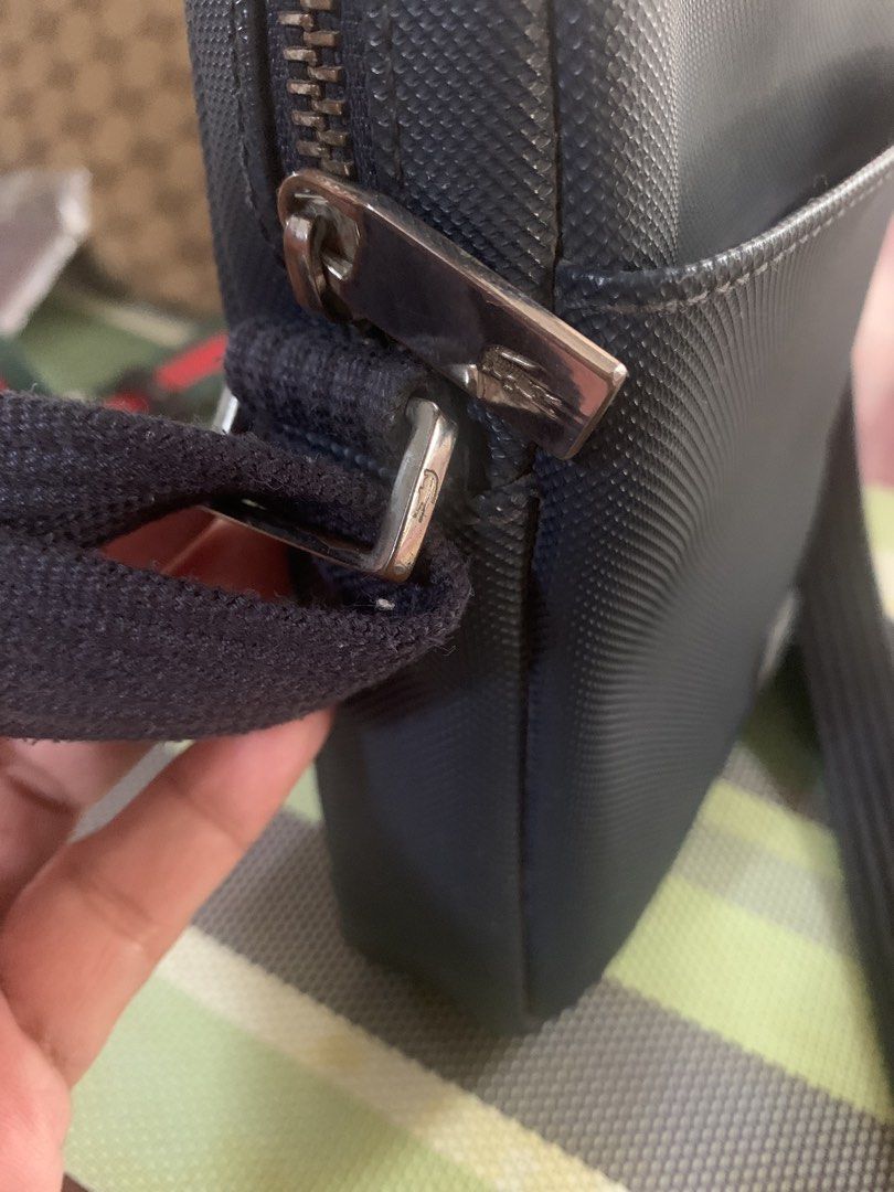 Lacoste Crossbody Bag Original (Category: Cross-body Bags) located in Paranaque City. Submitted by declutterby4angels (Listing ID 1464386916, Image 3). Description: - Dark blue Lacoste crossbody bag - Textured material with iconic crocodile logo - Adjustable strap for comfortable wear - Ideal for everyday use, keeping essentials handy - Clean and simple design.