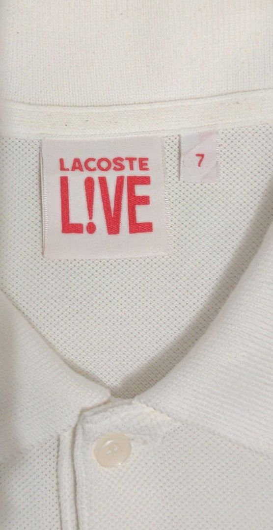 Lacoste Live White Polo Shirt Size 7 (Category: Tshirts & Polo Shirts ) located in Bago City. Submitted by louielinco (Listing ID 1464415321, Image 2). Description: - White Lacoste Live polo shirt - Features iconic blue crocodile logo - Made from 100% premium cotton - Tag indicates size 7 - Ideal for versatile casual wear.