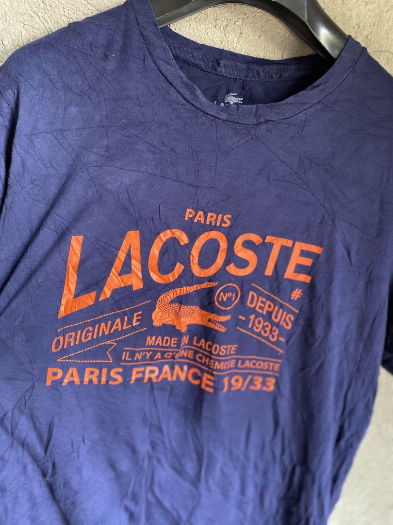 Lacoste Paris "Originale" T-Shirt (Category: Shirts) located in Dipolog. Submitted by wazienwathskin (Listing ID 1464383788, Image 2). Description: - Navy blue Lacoste t-shirt - Size 6 - Orange graphic print with "Paris Lacoste Originale" - "Made in Lacoste Paris France 19/33" detail - 100% Cotton - Made in France - Ideal for casual wear.