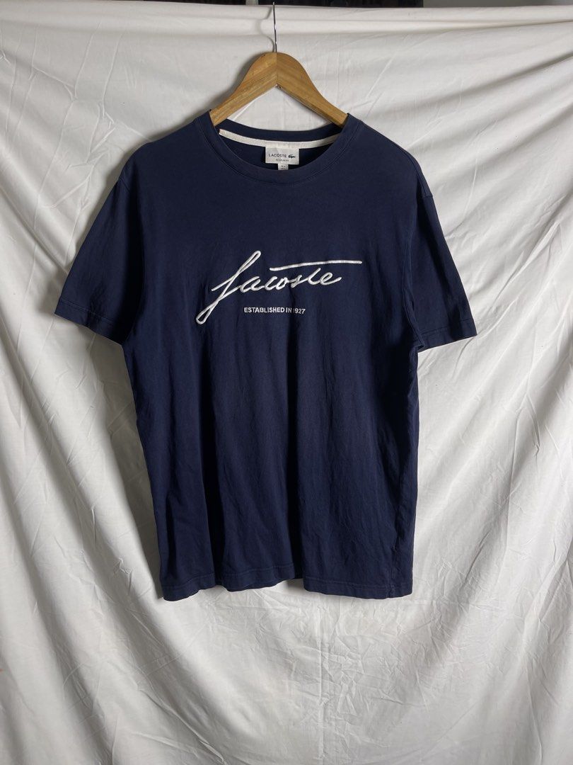 Lacoste Regular Fit T-shirt Navy Blue (Category: Tshirts & Polo Shirts ) located in Manila. Submitted by noahcastilljos363 (Listing ID 1464465296, Image 1). Description: - Navy blue Lacoste t-shirt - Classic script logo with 'Established 1927' detail - Size: US L / FR S - Fit: Regular - Origin: Made in Vietnam - A great staple piece for any wardrobe.
