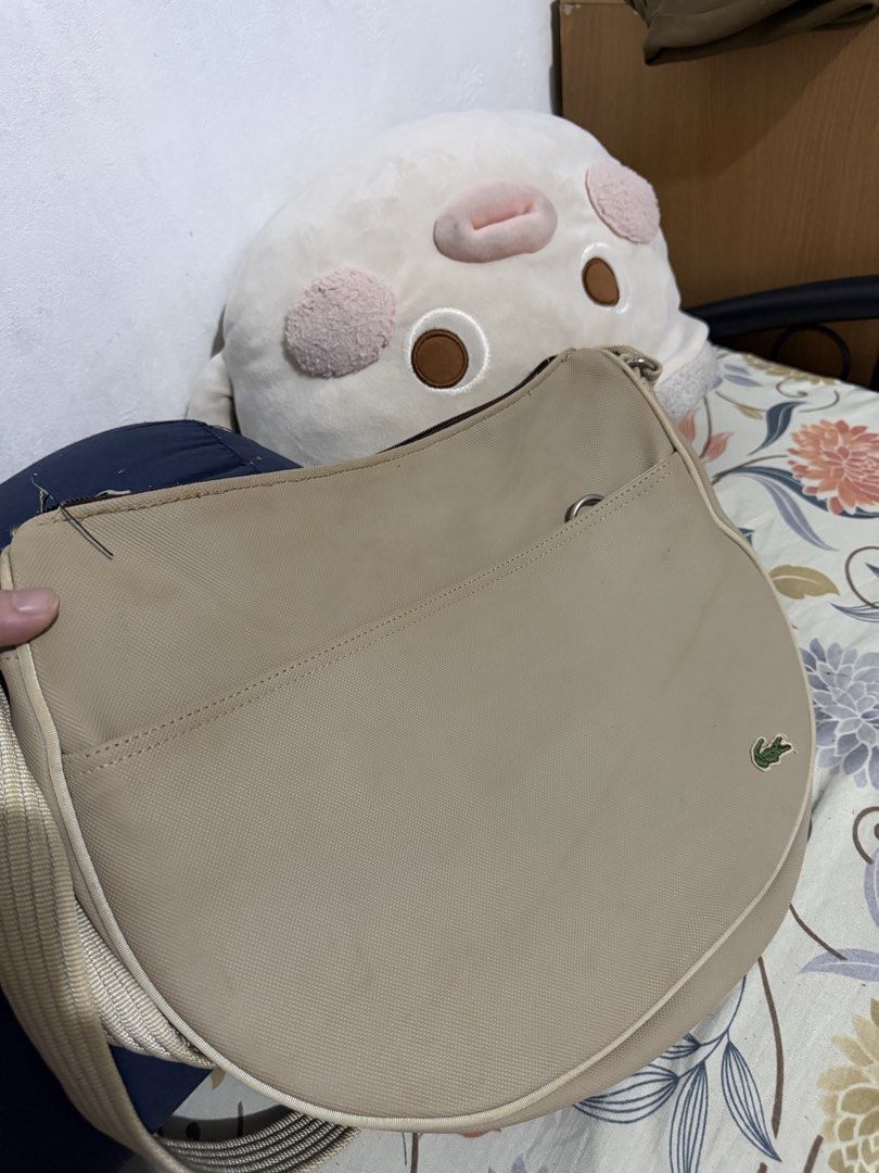 Lacoste Shoulder Bag (Category: Shoulder Bags) located in Quezon City. Submitted by yoooitschris (Listing ID 1464455021, Image 3). Description: Lacoste Shoulder bag Cream/beige color Heavily used. With some discolorations. Still in usable condition .