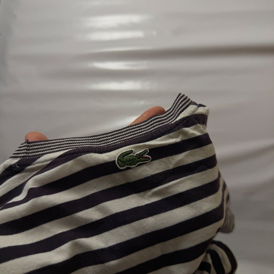 Lacoste Striped T-Shirt Size M (Category: Tshirts & Polo Shirts ) located in Manila. Submitted by johnedel_james (Listing ID 1464538385, Image 3). Description: - Classic black and white striped t-shirt by Lacoste. - Features the iconic crocodile logo on the chest. - Made from 100% soft cotton. - Tagged size M. - Perfect for everyday casual style..