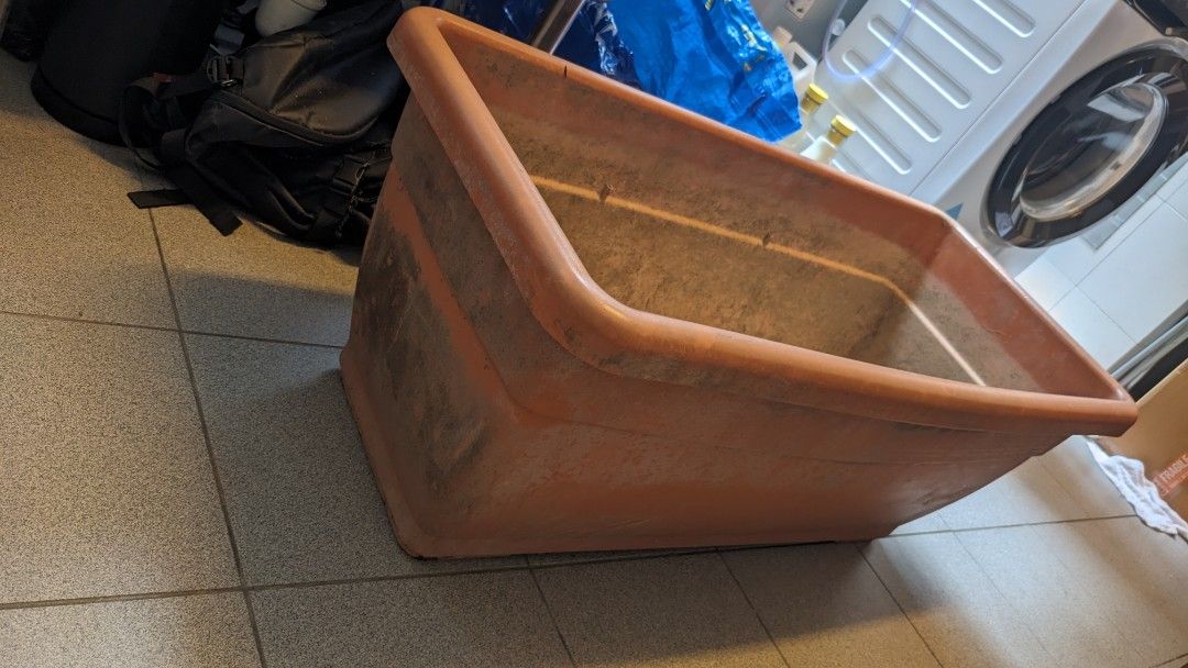2 Large Rectangular Planter Box (Category: Pots & Planters) located in Singapore. Submitted by vdt2024 (Listing ID 1464364770, Image 2). Description: - Large rectangular planter box - Made of durable orange plastic - Features drainage holes and raised interior sections - Suitable for outdoor garden or patio use - Shows some signs of previous outdoor use (marks/dirt inside and on sides) 2 pieces available 45w x 98 L, 40cm high..