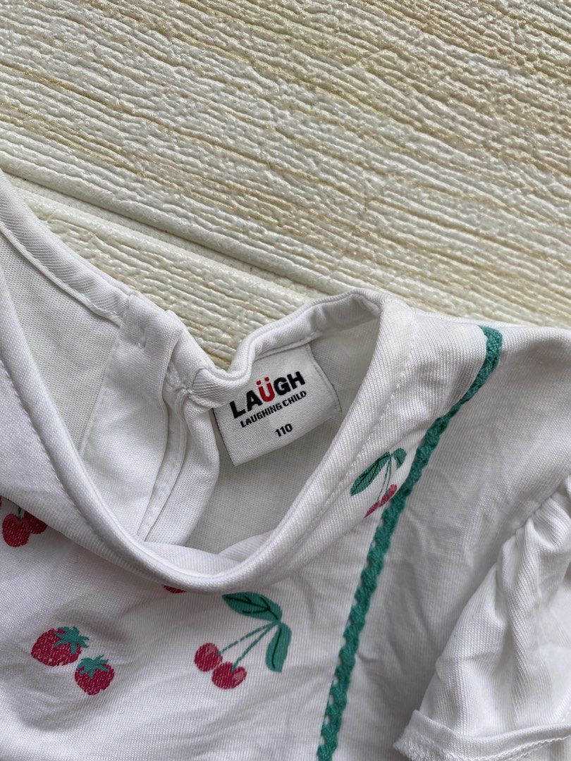 Laughing child cherry top (Category: Babies & Kids Fashion) located in Cebu City. Submitted by yjainani (Listing ID 1464372792, Image 3). Description: white toddler top features playful cherry and strawberry embroidery accented with green picot trim and flutter sleeves.