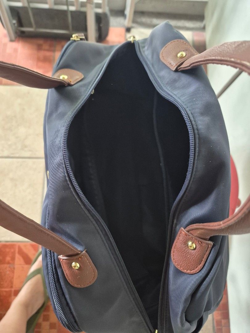 Legato Largo Navy Blue Nylon Duffel Bag (Category: Shoulder Bags) located in Pasig City. Submitted by happy_rebecca.cee (Listing ID 1464380436, Image 3). Description: - Brand: Legato Largo - Color: Navy Blue - Material: Nylon with Brown Leather Accents - Closure: Zip - Condition/FLAWS: Handles show wear and tear (as pictured) - Ideal for: Travel or everyday use.