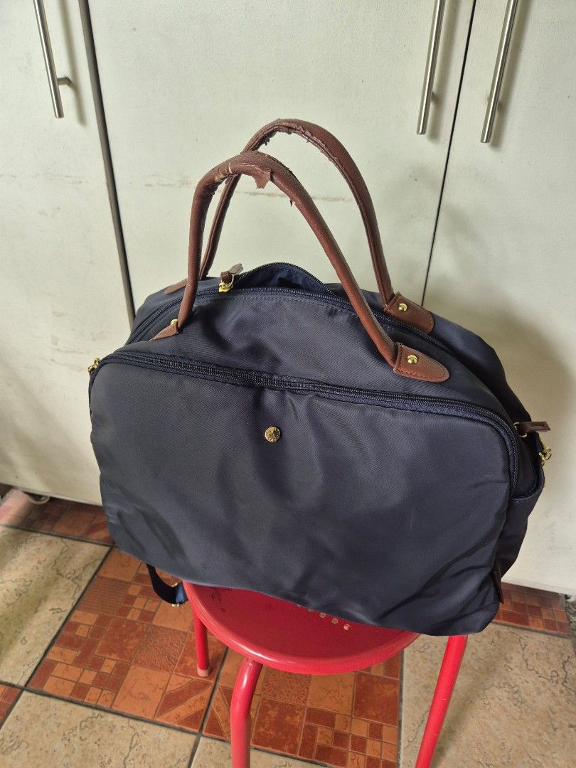 Legato Largo Navy Blue Nylon Duffel Bag (Category: Shoulder Bags) located in Pasig City. Submitted by happy_rebecca.cee (Listing ID 1464380436, Image 1). Description: - Brand: Legato Largo - Color: Navy Blue - Material: Nylon with Brown Leather Accents - Closure: Zip - Condition/FLAWS: Handles show wear and tear (as pictured) - Ideal for: Travel or everyday use.