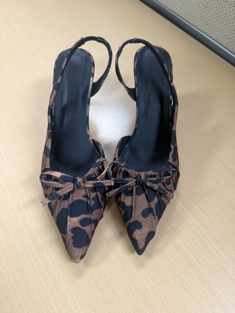 Leopard Print Slingback Heels with Bow Detail (Category: Heels) located in Quezon City. Submitted by lovedbymaxandmikoy (Listing ID 1464568144, Image 2). Description: - Chic leopard print slingback heels - Elegant pointed toe with a cute bow accent - Secure and comfortable elastic strap around the heel - Sturdy block heel for all-day wear - Size: 230 (Philippine size) / EU 36.5 - Perfect for adding a stylish touch to any outfit.