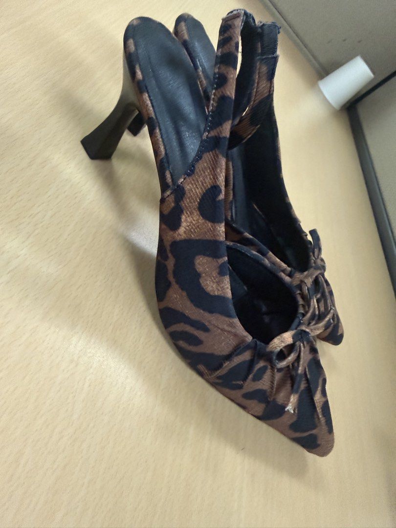 Leopard Print Slingback Heels with Bow Detail (Category: Heels) located in Quezon City. Submitted by lovedbymaxandmikoy (Listing ID 1464568144, Image 1). Description: - Chic leopard print slingback heels - Elegant pointed toe with a cute bow accent - Secure and comfortable elastic strap around the heel - Sturdy block heel for all-day wear - Size: 230 (Philippine size) / EU 36.5 - Perfect for adding a stylish touch to any outfit.
