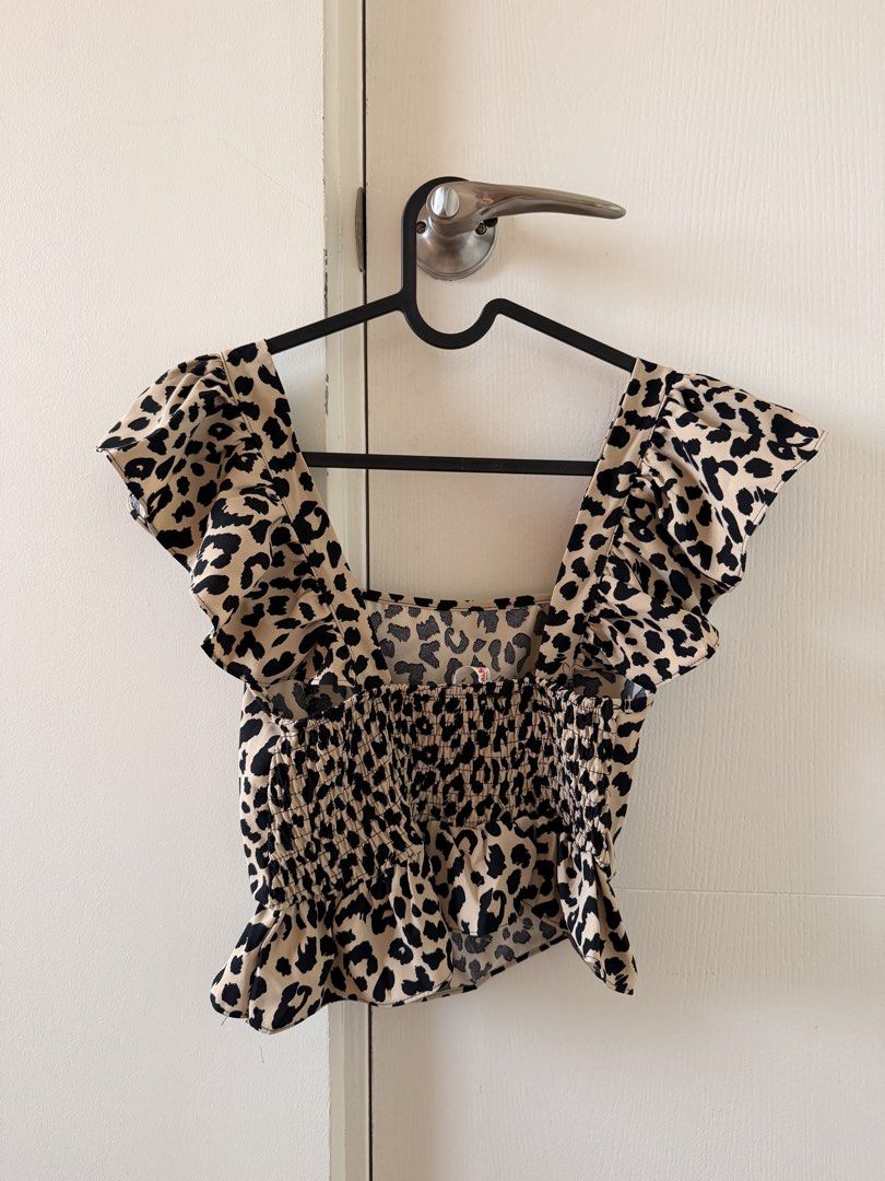 Leopard Print Smocked Square Neck Ruffle Sleeve Crop Top (Category: Blouses) located in Manila. Submitted by pvreal (Listing ID 1464443638, Image 2). Description: - Adorable leopard print crop top - Features a stylish square neckline - Cute ruffle sleeves - Smocked back ensures a comfortable and flexible fit - Cropped length, ideal for high-waisted bottoms - Easy to style for a fun, trendy look.