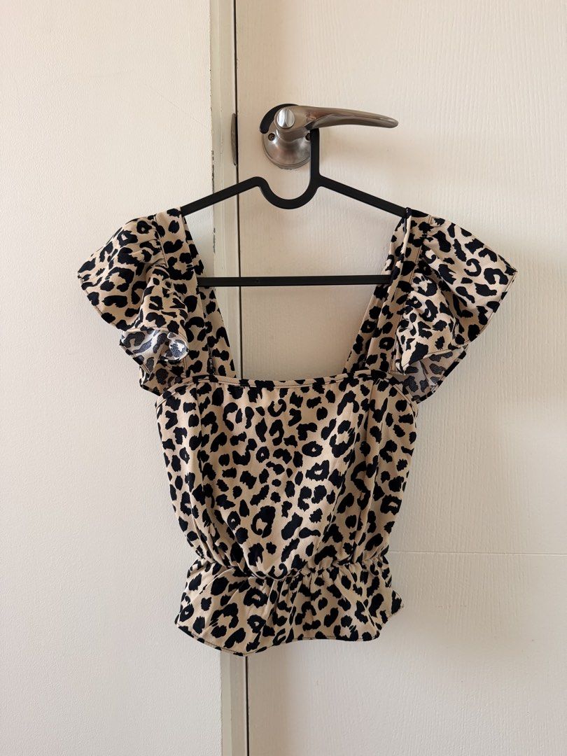 Leopard Print Smocked Square Neck Ruffle Sleeve Crop Top (Category: Blouses) located in Manila. Submitted by pvreal (Listing ID 1464443638, Image 1). Description: - Adorable leopard print crop top - Features a stylish square neckline - Cute ruffle sleeves - Smocked back ensures a comfortable and flexible fit - Cropped length, ideal for high-waisted bottoms - Easy to style for a fun, trendy look.