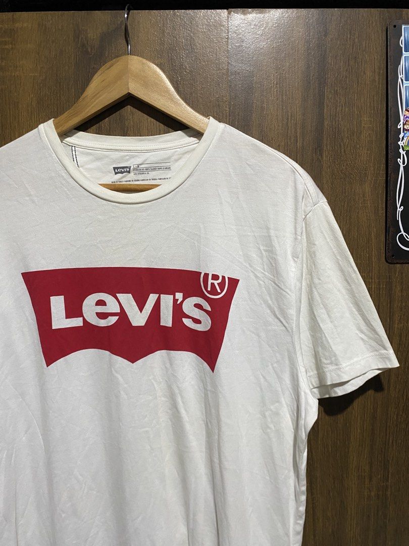 Levi's White T-Shirt with Red Logo (Category: Tshirts & Polo Shirts ) located in Antipolo. Submitted by cogiestamaria (Listing ID 1464378651, Image 3). Description: - Classic white Levi's t-shirt - size Large - dimes W22-L28 - no issue - color rate 9.5-10 - excellent condition - Features iconic red Batwing logo on the front - Standard fit - Made in Turkey - Versatile for casual outfits, pairs well with jeans or shorts - Essential wardrobe staple.