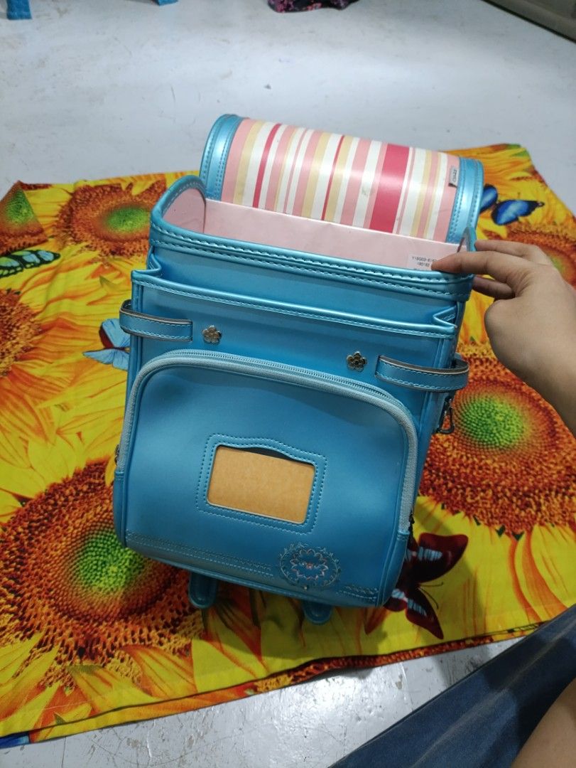 Light Blue Japanese Randoseru School Backpack (Category: Backpacks) located in Caloocan City. Submitted by parungaoai70385 (Listing ID 1464529789, Image 2). Description: - Cute light blue school backpack - Classic Japanese randoseru style - Main compartment and front zip pocket - Padded shoulder straps for comfort - Minor scuffs on exterior, good overall condition - Ideal for school or everyday use.