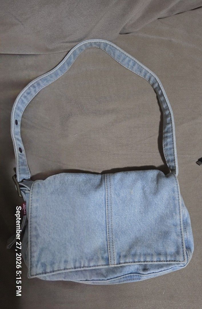 Light Wash Denim Shoulder Bag with Adjustable Strap (Category: Shoulder Bags) located in Quezon City. Submitted by cindy_764 (Listing ID 1464445683, Image 1). Description: - Cute light wash denim shoulder bag - Adjustable strap with button holes - Interior pockets for organization - Great for everyday use - Simple and classic style.