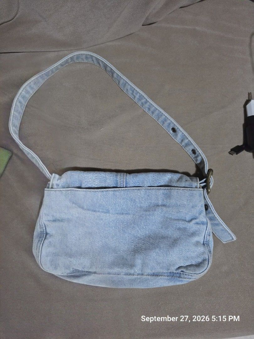 Light Wash Denim Shoulder Bag with Adjustable Strap (Category: Shoulder Bags) located in Quezon City. Submitted by cindy_764 (Listing ID 1464445683, Image 2). Description: - Cute light wash denim shoulder bag - Adjustable strap with button holes - Interior pockets for organization - Great for everyday use - Simple and classic style.