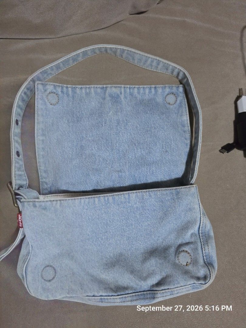 Light Wash Denim Shoulder Bag with Adjustable Strap (Category: Shoulder Bags) located in Quezon City. Submitted by cindy_764 (Listing ID 1464445683, Image 3). Description: - Cute light wash denim shoulder bag - Adjustable strap with button holes - Interior pockets for organization - Great for everyday use - Simple and classic style.