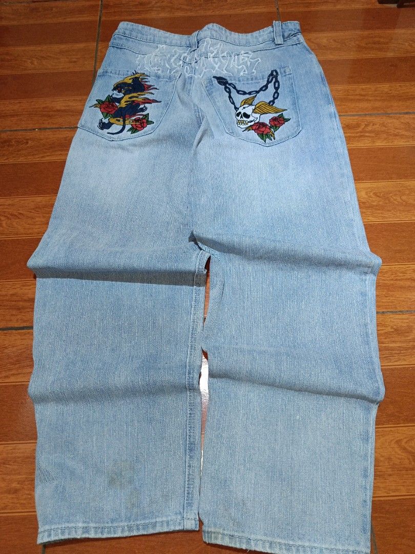 Light Wash Embroidered Denim Jeans (Category: Jeans) located in Manila. Submitted by grimjoww09 (Listing ID 1464355732, Image 2). Description: - Light wash denim jeans - Unique embroidery: Dragon and skull design on back pockets - Graffiti-style patch on front pocket - Relaxed fit - Ideal for casual wear.