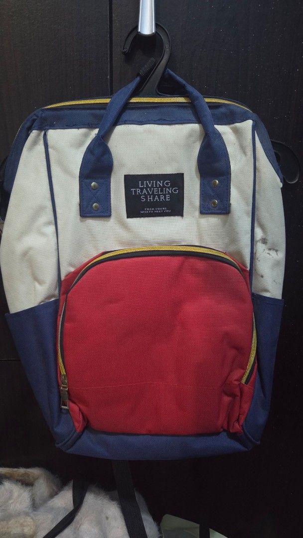 Living Traveling Share Backpack - Cream, Red, Navy (Category: Backpacks) located in Quezon City. Submitted by kctheexplorer05 (Listing ID 1464521176, Image 1). Description: - Stylish color block design (cream, red, navy) - Convenient front zip pocket - Multiple internal compartments for organization - Adjustable straps for a comfortable fit - Ideal for everyday use or travel adventures -visible stain (not sure if can wash it) and zipper lock in f