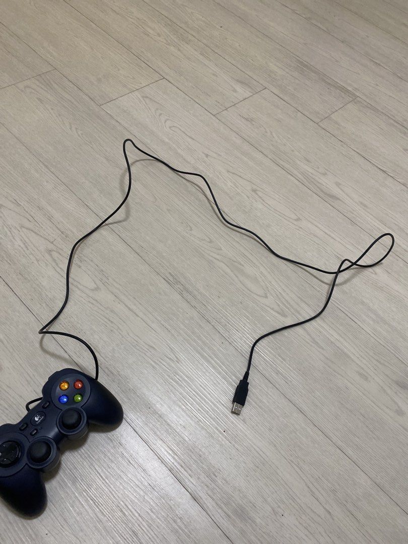 Logitech USB Game Controller (Category: Controllers) located in Singapore. Submitted by safepenguin_788ad3 (Listing ID 1464372010, Image 1). Description: - Logitech wired game controller - Connects via USB - Perfect for PC gaming - Responsive buttons and joysticks - Game-ready condition.