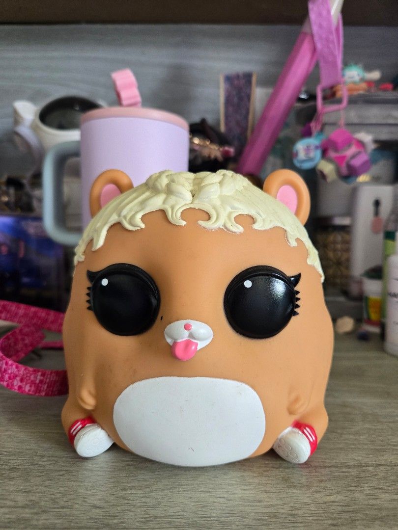 LOL Surprise Biggie Pets MC Hammy (Category: Kids Toys) located in Mangaldan. Submitted by jacqueline31426 (Listing ID 1464386970, Image 1). Description: - Adorable LOL Surprise Biggie Pets MC hammy - Features cute pink straps with a repeating pattern. - Includes a coin slot on the back for easy savings. - Ideal for kids to carry small essentials. - A must-have accessory for any LOL Surprise enthusiast..