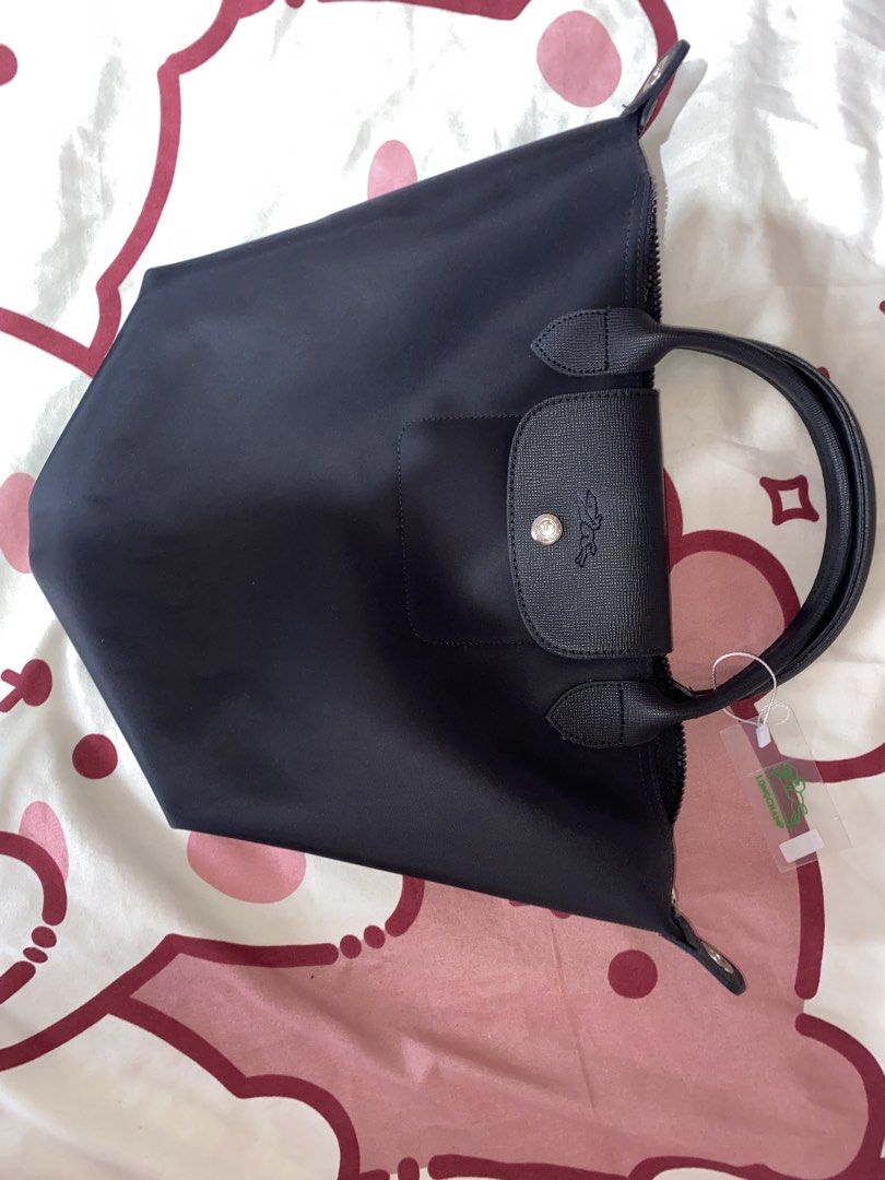 Longchamp Le Pliage Neo Bag (Category: Luxury Bags & Wallets) located in Manila. Submitted by valcappuccina (Listing ID 1464450704, Image 1). Description: - Authentic Black Longchamp top handle bag - Features signature embossed Longchamp logo on leather trim - Secure zipper closure - Comes with original tags attached - Ideal for everyday use.
