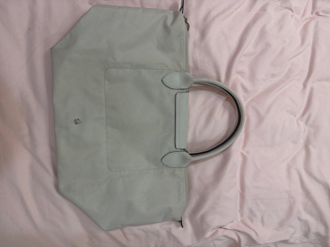 Longchamp Le Pliage Tote Bag Light Grey (Category: Luxury Bags & Wallets) located in Santa Rosa. Submitted by decluttering_. (Listing ID 1464468425, Image 3). Description: - AUTHENTIC Light grey Longchamp tote bag - Classic foldable design - Genuine leather handles and trim - Secure zipper closure with snap button flap - Spacious interior, ideal for everyday or travel.